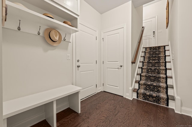 mudroom featuring dark wood-style flooring and baseboards