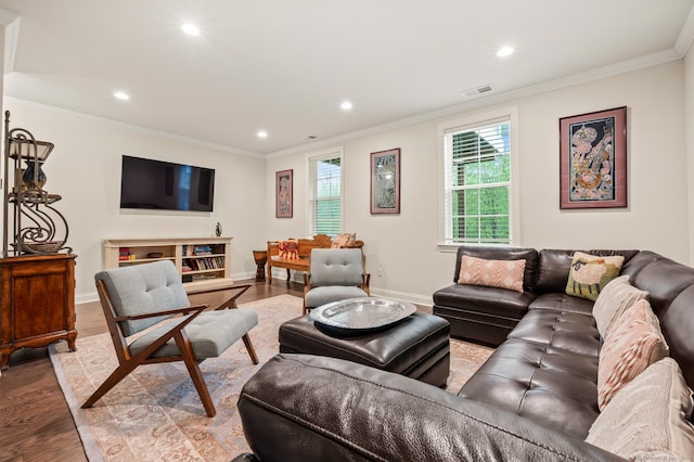 living area with wood finished floors, recessed lighting, baseboards, and crown molding