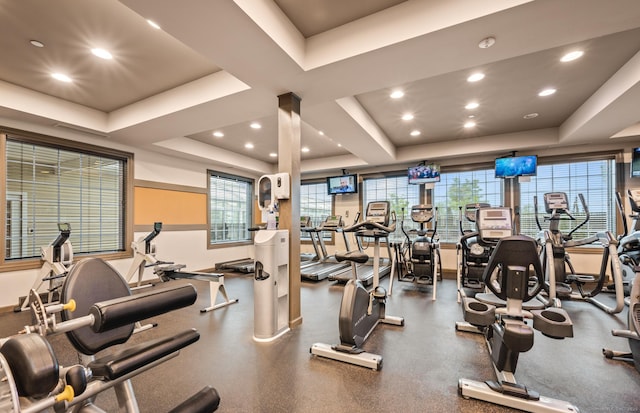 exercise room featuring a tray ceiling and recessed lighting