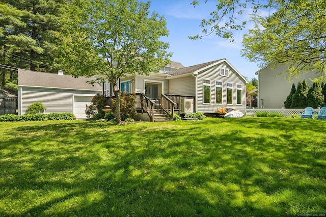 rear view of house featuring a garage and a deck