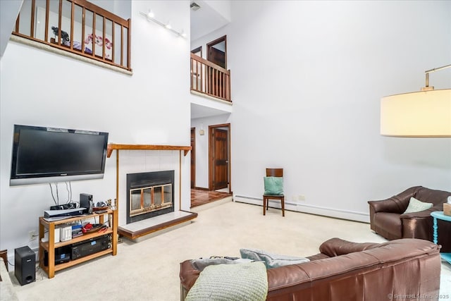6 Kristy Dr, Bethel, CT 06801 - carpeted living area with a tile fireplace, a baseboard heating unit, and a high ceiling