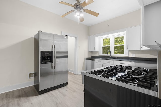 516 Savin Ave, West Haven, CT 06516 - kitchen with appliances with stainless steel finishes, light wood-style flooring, dark countertops, white cabinets, and ceiling fan