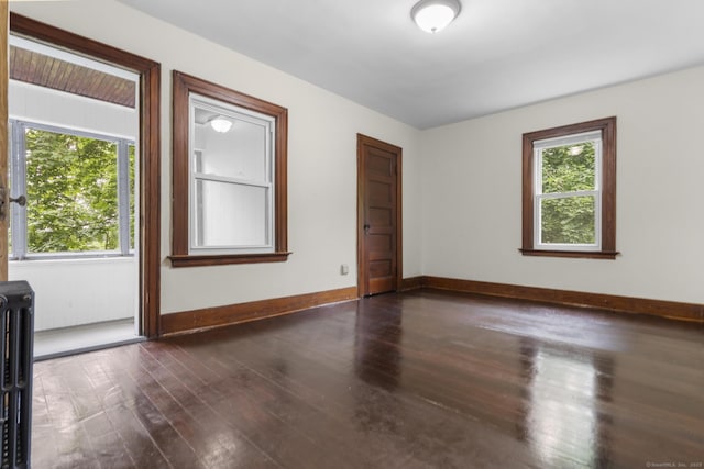 516 Savin Ave, West Haven, CT 06516 - spare room featuring dark wood-type flooring and radiator
