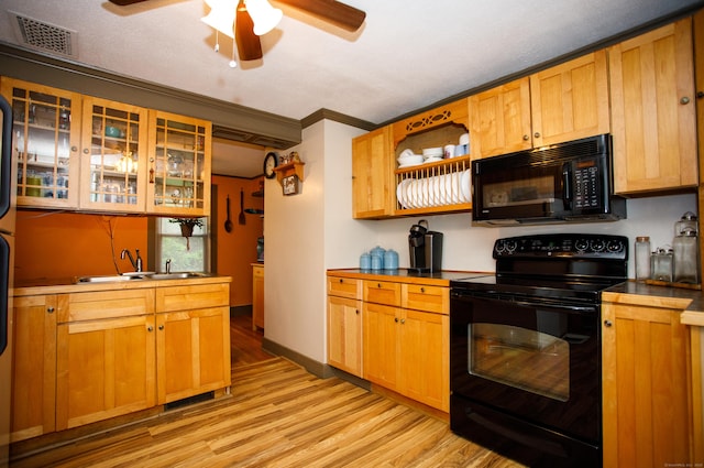 kitchen featuring open shelves, light wood-type flooring, black appliances, visible vents, and a ceiling fan