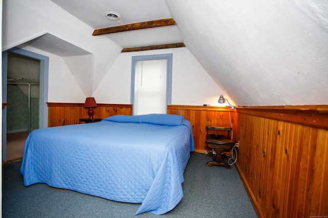 bedroom featuring carpet, visible vents, wood walls, a wainscoted wall, and vaulted ceiling