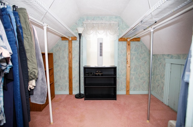spacious closet featuring lofted ceiling and carpet flooring