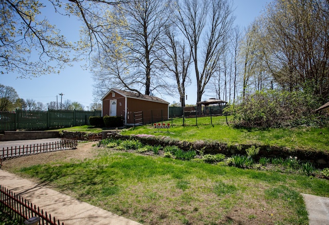 view of yard featuring an outdoor structure and fence