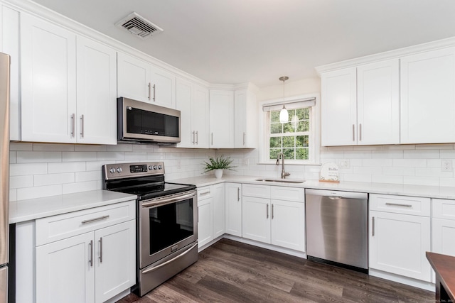 26 Sharon Cir, Meriden, CT 06450 - kitchen with stainless steel appliances, light countertops, and white cabinets
