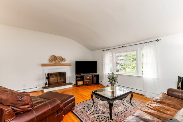 26 Sharon Cir, Meriden, CT 06450 - living area with vaulted ceiling, baseboard heating, a baseboard heating unit, a glass covered fireplace, and light wood-style floors