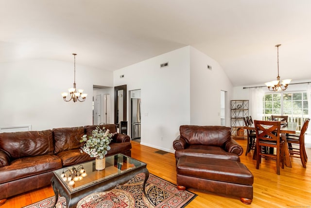26 Sharon Cir, Meriden, CT 06450 - living area with a chandelier, lofted ceiling, and light wood-style flooring