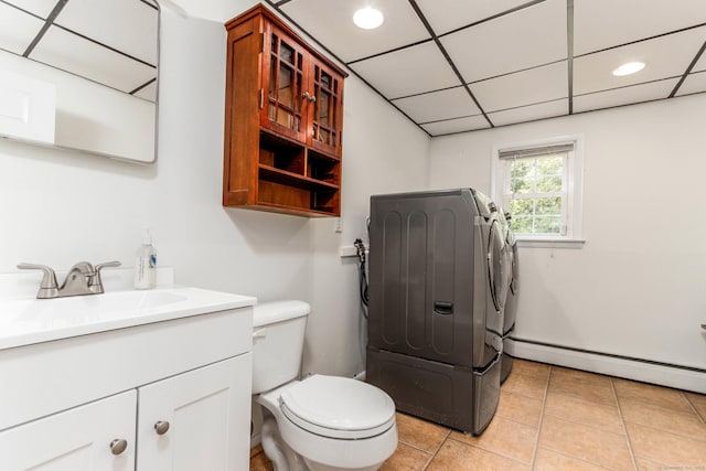 26 Sharon Cir, Meriden, CT 06450 - bathroom featuring vanity, a baseboard heating unit, washer and dryer, tile patterned flooring, and recessed lighting
