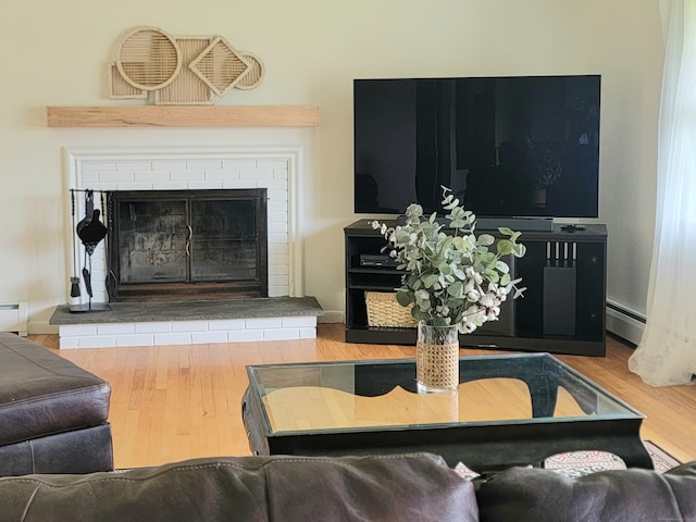 26 Sharon Cir, Meriden, CT 06450 - living room featuring a brick fireplace, a baseboard radiator, and wood finished floors