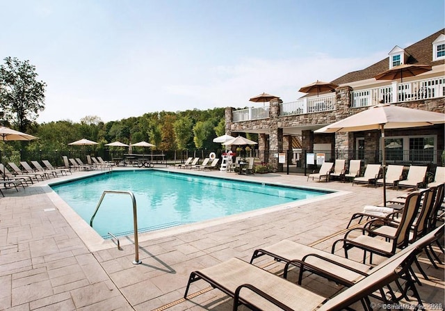 pool featuring a patio area and fence