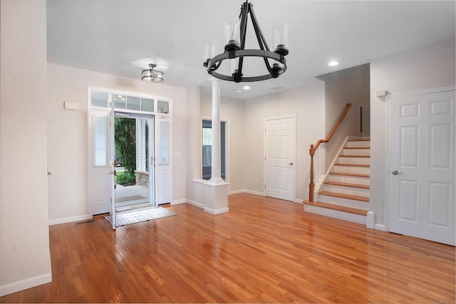 foyer with a notable chandelier, recessed lighting, baseboards, stairs, and light wood-style floors