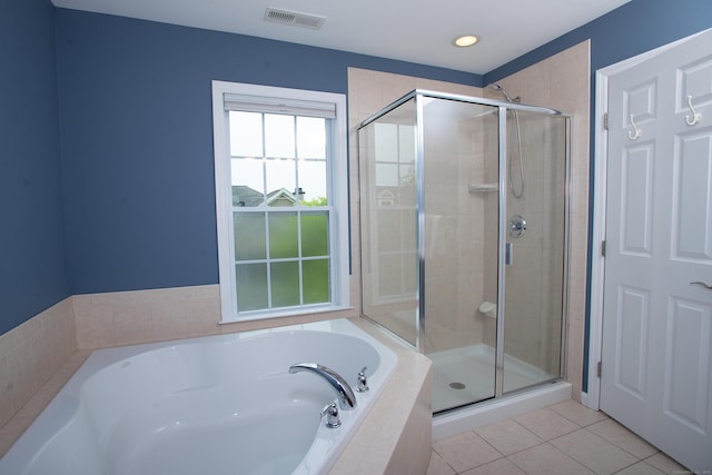 full bathroom featuring a garden tub, visible vents, tile patterned flooring, and a shower stall