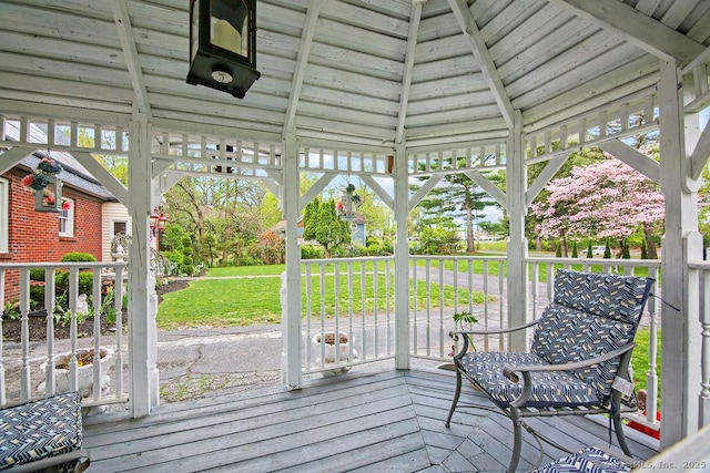 wooden deck with a gazebo and a yard