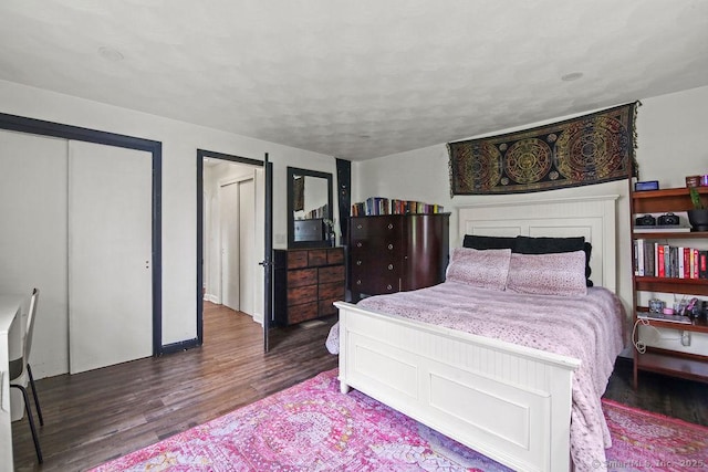 bedroom featuring wood finished floors and a textured ceiling
