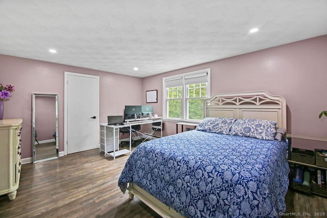 bedroom with wood finished floors, recessed lighting, and baseboards
