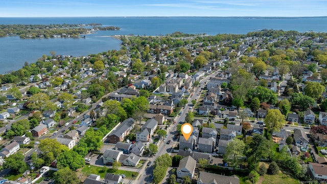 aerial overview of property's location featuring nearby suburban area and a large body of water