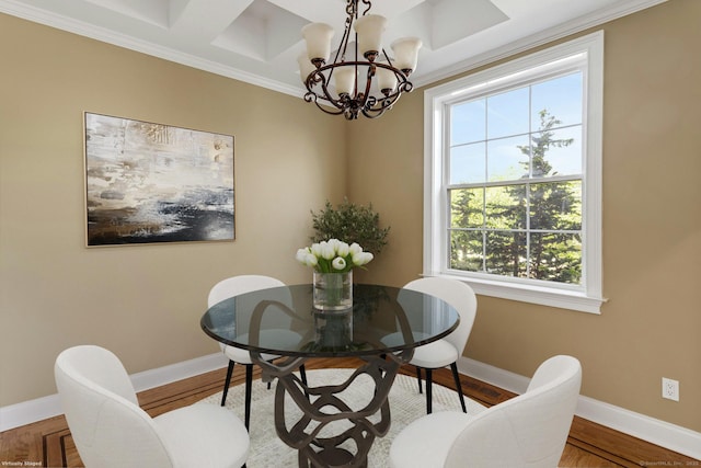dining room featuring healthy amount of natural light, baseboards, a chandelier, crown molding, and wood finished floors
