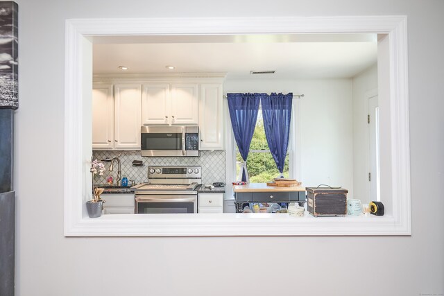 17 Grays Farm Rd, Weston, CT 06883 - kitchen with stainless steel appliances, tasteful backsplash, white cabinetry, and recessed lighting