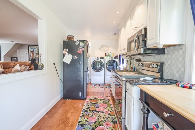 17 Grays Farm Rd, Weston, CT 06883 - kitchen featuring independent washer and dryer, stainless steel appliances, light wood-style flooring, white cabinetry, and a sink