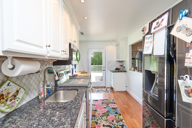 17 Grays Farm Rd, Weston, CT 06883 - kitchen featuring stainless steel appliances, a sink, white cabinets, backsplash, and light wood-style floors
