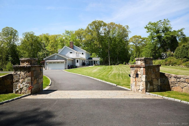 17 Grays Farm Rd, Weston, CT 06883 - view of front facade with asphalt driveway, a front lawn, a garage, and a chimney