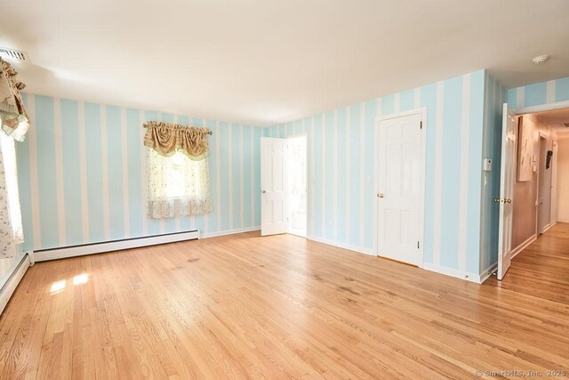 17 Grays Farm Rd, Weston, CT 06883 - empty room featuring wallpapered walls, wood finished floors, baseboard heating, and baseboards