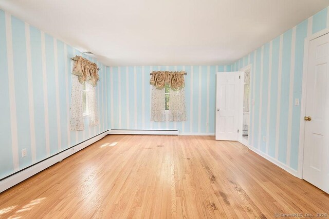 17 Grays Farm Rd, Weston, CT 06883 - spare room featuring wood finished floors, wallpapered walls, baseboard heating, and a baseboard heating unit