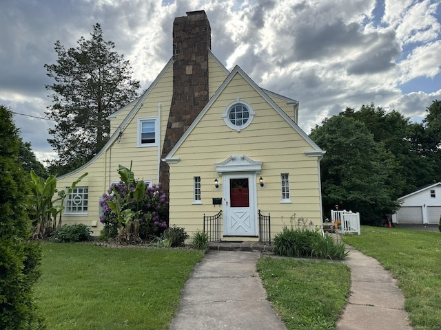 view of front of property with a front lawn and a chimney