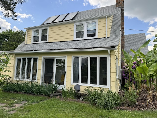 135 Lambert Ave, Meriden, CT 06451 - back of house with roof mounted solar panels, a chimney, and a shingled roof