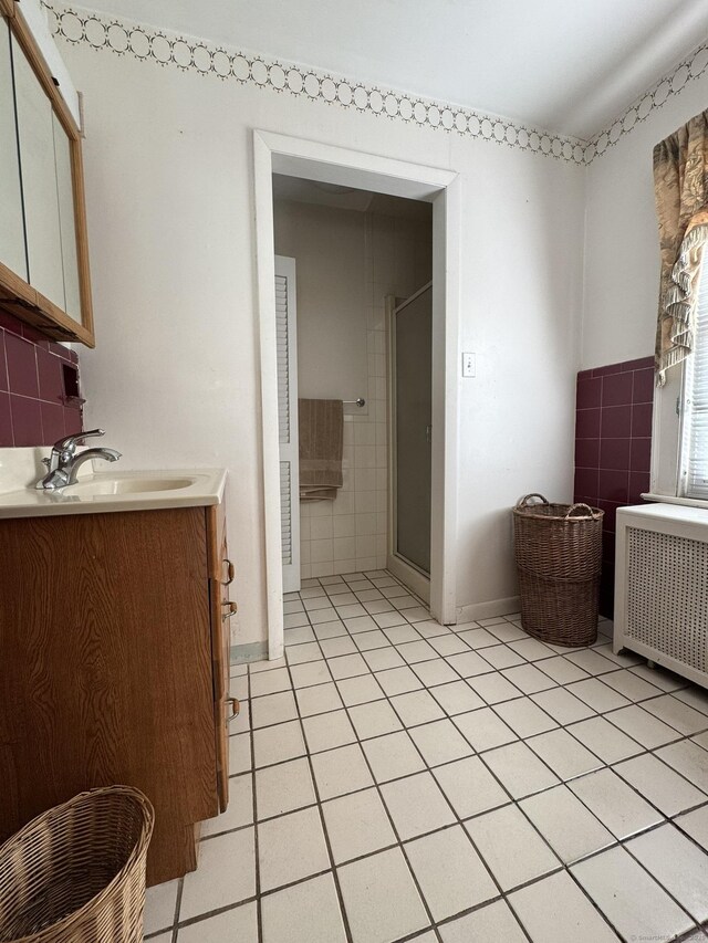 135 Lambert Ave, Meriden, CT 06451 - bathroom featuring radiator, tile patterned flooring, a stall shower, tile walls, and vanity
