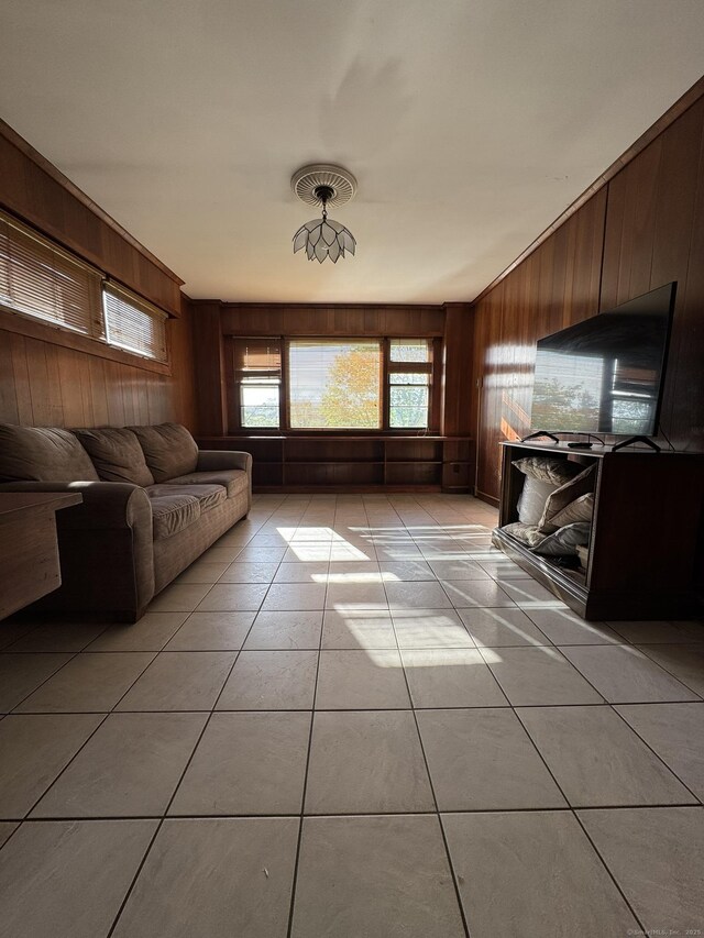 135 Lambert Ave, Meriden, CT 06451 - living room with wooden walls and light tile patterned floors