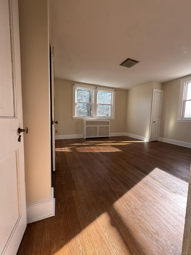 135 Lambert Ave, Meriden, CT 06451 - empty room featuring wood finished floors, radiator heating unit, and baseboards