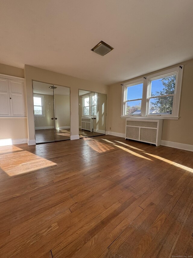 135 Lambert Ave, Meriden, CT 06451 - spare room featuring radiator, dark wood finished floors, plenty of natural light, and baseboards