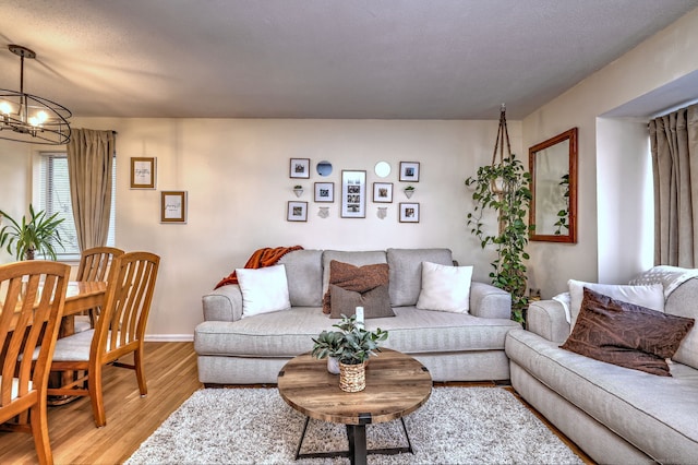 529 Woodward Ave Apt D, New Haven, CT 06512 - living area featuring a chandelier, light wood-style floors, and baseboards