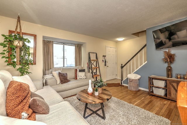 529 Woodward Ave Apt D, New Haven, CT 06512 - living room featuring hardwood / wood-style floors, stairway, a textured ceiling, and baseboards