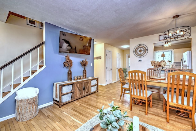529 Woodward Ave Apt D, New Haven, CT 06512 - dining area featuring hardwood / wood-style floors, baseboards, a textured ceiling, and stairway