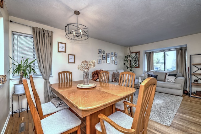 529 Woodward Ave Apt D, New Haven, CT 06512 - dining room featuring a chandelier, wood finished floors, and a textured ceiling