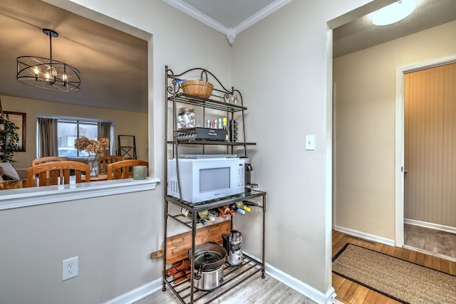 529 Woodward Ave Apt D, New Haven, CT 06512 - dining space with wood finished floors, a chandelier, baseboards, and ornamental molding