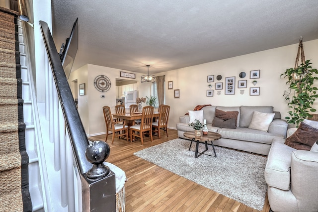 529 Woodward Ave Apt D, New Haven, CT 06512 - living room featuring hardwood / wood-style floors, stairs, a textured ceiling, and baseboards