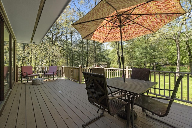 192 Thompson Hill Rd, Portland, CT 06480 - wooden deck with outdoor dining space, view of scattered trees, and a lawn