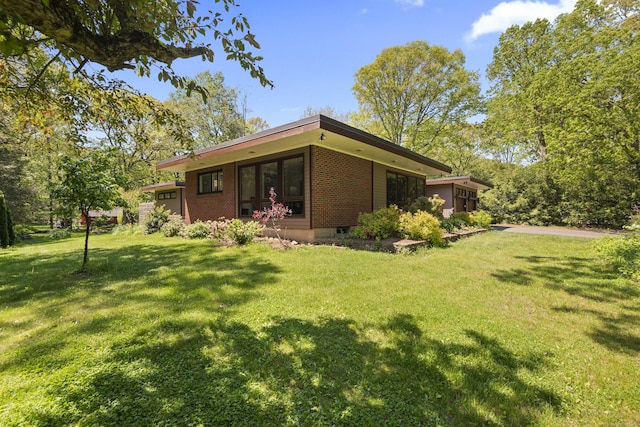 192 Thompson Hill Rd, Portland, CT 06480 - back of property with brick siding, a yard, and a garage
