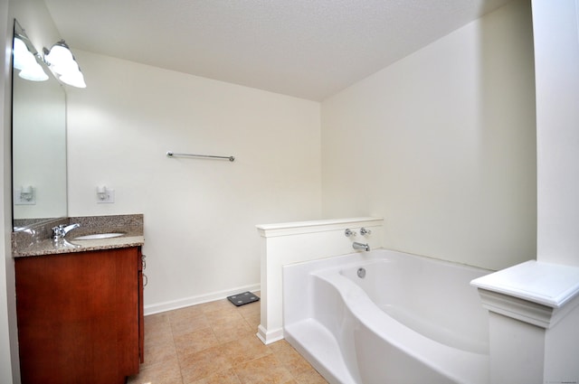 bathroom featuring a garden tub, baseboards, vanity, and tile patterned flooring