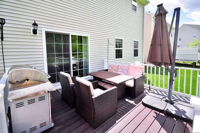 wooden deck featuring outdoor dining area, grilling area, and a lawn