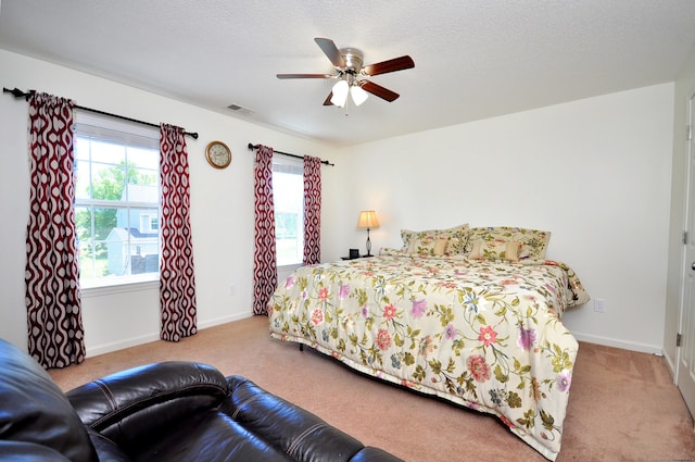 carpeted bedroom featuring baseboards and a ceiling fan