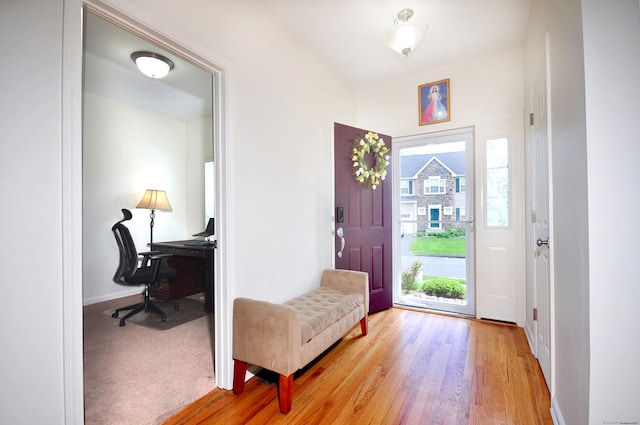 foyer entrance featuring baseboards and light wood-style floors