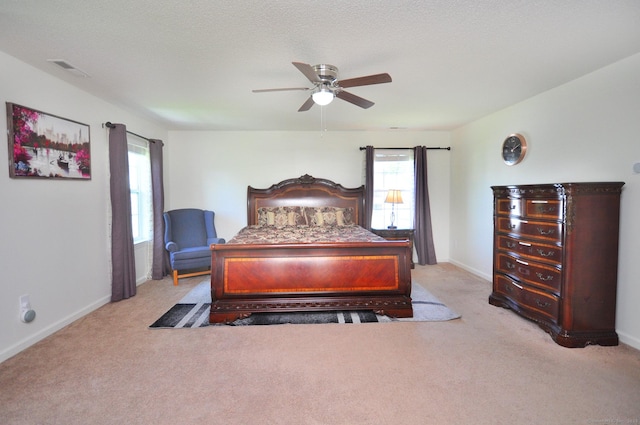 carpeted bedroom featuring baseboards and ceiling fan