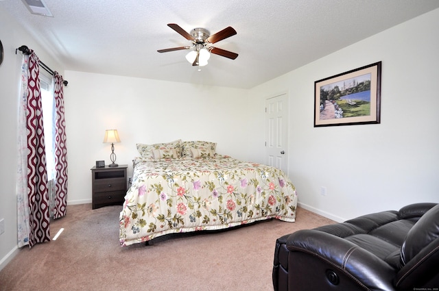 bedroom featuring carpet, baseboards, a textured ceiling, and ceiling fan